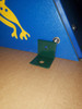 Infinity Playgrounds Climbing Wall With Tunnel, close-up of a green metal mounting bracket attached to a textured blue climbing wall with a yellow lizard graphic.