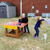 Infinity Playgrounds Bubble Station Activity Table, children playing outdoors with soap bubbles around the colorful activity table.