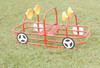Infinity Playgrounds Playground Passenger Car, red and yellow playground ride-on vehicle with steering wheels and seat area on a grassy field.
