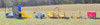 Infinity Playgrounds Tool Truck Role Play Center, colorful playground toy trucks with slides and tunnels in an open grassy field.