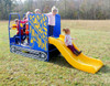 Infinity Playgrounds Lil Dumpy Toddler Slide, children playing on colorful outdoor playground equipment with a yellow slide and blue structure.