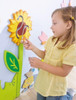 HABA Pro Sunflower w/Little Bee Interactive Wall Decor, child interacting with colorful sunflower and bee wall decorations.