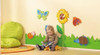 HABA Pro Sunflower with Little Bee Interactive Wall Decor, colorful children's wall art with a sunflower, butterfly, ladybug, and hedgehog design in a playroom setting.