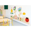 Moje Bambino Meadow Sensory Wall Panel, colorful children’s sensory wall panel with flower and ladybug designs in a classroom setting.