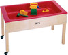 Jonti-Craft Children's Sensory Table, red plastic sensory table with wooden legs and small toys inside.