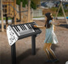 Playground Prodigy ~ELECTRIFIED~ Rock Star Playground Keyboard, children's outdoor musical instrument with a digital piano design, placed on a stand in a playground setting. Playground Prodigy ~ELECTRIFIED~ Rock Star Playground Keyboard, children's outdoor musical instrument with a digital piano design, placed on a stand in a playground setting.