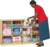 Jonti-Craft 12 Tub Large Mobile Storage Unit, a woman organizing colorful toys and supplies in a wooden storage unit with 12 removable tubs.