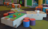 Playscapes 3-Branch Pinwheel Triple Discovery Table, play area with colorful seating and educational toys.