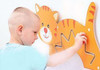 Moje Bambino Kitten Shift Sensory Wall Panel Toy, a child interacting with an engaging wall-mounted sensory toy featuring a cute orange and white tiger design.