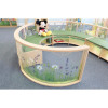 Whitney Brothers Nature View Curved Divider Panel 24" H, a curved divider panel with a nature-inspired floral design and a plush Mickey Mouse toy sitting on top in a children's play area.