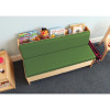 Whitney Brothers Comfy Reading Center Couch, green cushioned kids' reading sofa with built-in bookshelf behind the backrest, holding children's books and plush toys in a classroom or playroom setting.