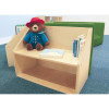 Whitney Brothers Five Section Reading Nook with built-in Bookshelves, wooden children's reading nook with a plush teddy bear and books, and green cushion seating in the background.