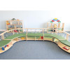 Whitney Brothers Nature View Straight Couch, children's play furniture with a curved design, green cushioned seating, and surrounded by toys and display shelves.