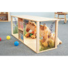 Whitney Brothers Nature View Discovery Crawl-Thru Cabinet, children’s play cabinet featuring nature-themed printed sides with images of flowers and animals, and a plush lion toy inside.