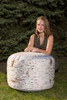Playscapes Woodsmen Naturescape Tree Stump, a realistic faux tree stump outdoor furniture piece in a natural setting.