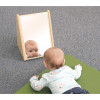 Whitney Brothers Infant Mirror Stand, baby looking at a mirror placed on the floor showing their reflection.