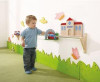 HABA Pro Push Along Train Rail Wall Activity, a young boy playing with a wooden train on a wall-mounted track setup in a children's playroom. HABA Pro Push Along Train Rail Wall Activity, a young boy playing with a wooden train on a wall-mounted track setup in a children's playroom.
