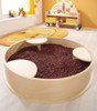 HABA Pro Sensory Bath with Lid, circular wooden sensory bath filled with red beans in a playroom setting.