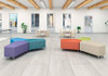 Moje Bambino Star Upholstered Bench Ottomans, colorful modular sofa with purple, teal, orange, beige, and green sections in modern interior space.