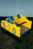 Playtime Playground Equipment Race Car Spring Rider, colorful yellow and blue children's spring rider with a race car design and wheels, suitable for outdoor play areas.