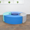 Children's Factory Tranquility Curve Soft Seating - 5 Pieces, colorful semi-circular cushioned seats arranged in a circle in a room with wooden flooring and a white wall with a window and potted plants.