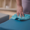 Children's Factory Tranquility Gray Soft Ottoman, person cleaning the blue surface with a blue cloth.