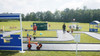 Infinity Playgrounds Formula One Road Course Trike Track, outdoor miniature racing track with small tricycles, a sports-themed setting, and children playing on the track.