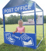 Infinity Playgrounds Post Office Outdoor Playhouse, children playing at a miniature post office with stamps and mailboxes.