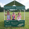 Infinity Playgrounds Farmers Market Outdoor Playhouse, children playing and selling fruits and vegetables at a miniature outdoor farmers market setup.