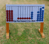 Infinity Playgrounds Connect 4 Playground Game, outdoor interlocking grid connect four game with red and blue discs on a stand.