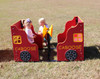 Infinity Playgrounds Infinity Express Caboose Outdoor Climber, red and yellow toddler playground train with two children playing on it outdoors on a grassy field.