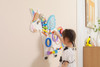 SPARK & WOW Unicorn Activity Wall Panel, colorful wooden active play wall for children with various interactive elements including a unicorn head, rainbow, and beads.