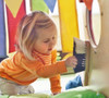HABA Pro Toddler Sensory Activity Discovery Snail, young girl engaging with a sensory activity using a brush on a colorful snail-shaped display.