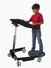 Gressco Kids Ergonomic Sit-Stand Mobile Student Desk, a young boy standing on a black ergonomic sit-stand mobile desk with adjustable height, four wheels for mobility, and a spacious surface for studying or gaming.