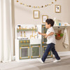 Teamson Kids Versailles Wooden Deluxe Play Kitchen Set, a child playing with a realistic and stylish wooden toy kitchen in a well-decorated play area.