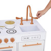 Teamson Kids Little Chef Milano Two-Piece Modular Modern Delight Play Kitchen Set, close-up of the toy kitchen with brown faucet, faux stovetop, and oven, featuring realistic design and interactive elements for children.