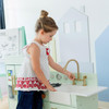 Teamson Kids Little Chef Charlotte Modern Mint Play Kitchen, a child playing with a modern mint-colored toy kitchen with gold accents, sink, and stove in a bright room.