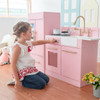 Little Chef Charlotte Modern Pink Play Kitchen girl playing with stove