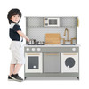 Teamson Kids Little Chef Berlin Gray Play Kitchen with Cookware, child playing with toy kitchen set including pots and pans.