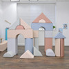 Children's Factory Elements Large Foam Building Blocks A - Set of 21, colorful soft foam construction blocks resembling houses and towers in pastel shades of blue, pink, gray, and cream arranged indoors. Children's Factory Elements Large Foam Building Blocks A - Set of 21, colorful soft foam construction blocks resembling houses and towers in pastel shades of blue, pink, gray, and cream arranged indoors.