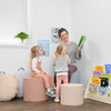 Children's Factory Soft Ottoman Trio - Elements, soft padded kid-friendly ottomans in pastel pink, beige, and blue used as seating in a classroom or library setting.