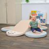 Children's Factory Butterfly Soft Play Climber, Elements, soft play center with a smiling baby sitting on a beige and brown butterfly-shaped climbing structure in a children's room.