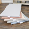 Children's Factory Nap Time Rest Mats, Elements - Set of 5, neatly stacked in pastel colors on a wooden floor inside a classroom or daycare setting.