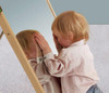 HABA Pro Large Mirror Triangle House, child playing and looking at their reflection in the mirror.