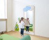 HABA Pro Fairy Tale Cloud Safety Wall Mirror, a child safety mirror with a cloud design, mounted on a wall in a children's room.