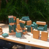 Playmore Designs Eco Building Blocks, colorful wooden building blocks arranged on a wooden surface outdoors.