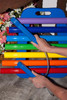 Playmore Designs EnSoul Rainbow Portable Chimes 7 Note, vibrant multicolored musical chimes being played with a blue mallet.