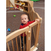 Jonti-Craft Welcome Gate Classroom Divider - KYDZ Suite® E-height, a wooden safety gate with a child behind it in a classroom setting.