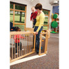 Jonti-Craft Welcome Gate Classroom Divider - KYDZ Suite® E-height, a wooden safety gate in a preschool classroom with children playing and a caregiver supervising.