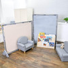 Children's Factory Elements Big Screen Fog Blue PlayPanel, children's playroom with two gray foam panels and a children's book display with toys and books.